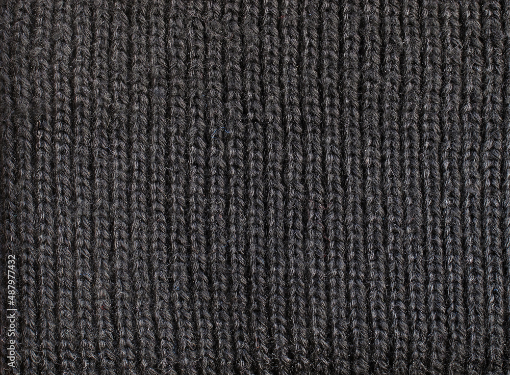 Fragment of a black woolen cloth knitted with an English ribbing pattern Fragment of a black woolen cloth knitted with an English ribbing pattern