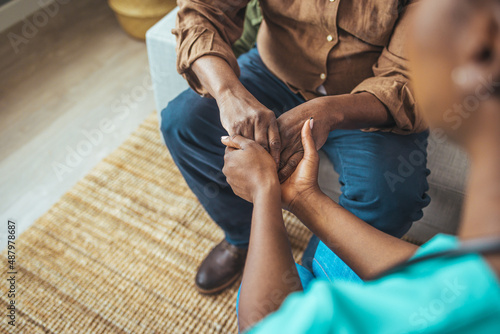 Closeup shot of a young woman holding a senior man's hands in comfort. Cropped shot of a senior man and a nurse holding hands. Not just a caregiver but a confidant