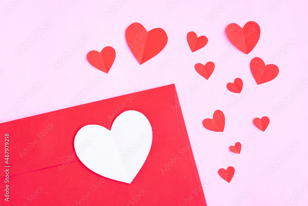 Red envelope with heart papercut on pink background