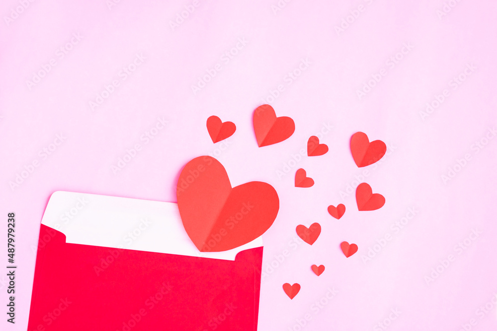 Red envelope with heart papercut on pink background