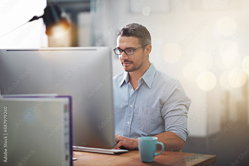 Getting things done, one click at a time. Cropped shot of a businessman working at his desk. Getting things done, one click at a time. Cropped shot of a businessman working at his desk.