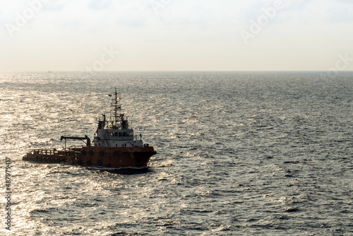 An anchor handling tug boat sailing at an offshore oil field