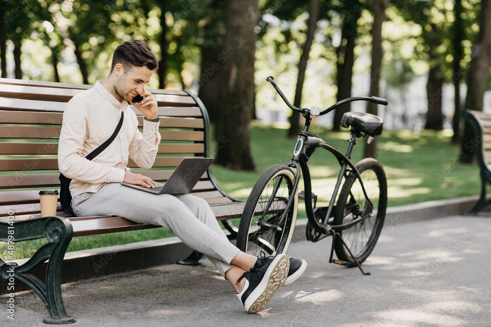 Important talk with client. Handsome young man with stubble in casual clothes working on laptop Important talk with client. Handsome young man with stubble in casual clothes working on laptop