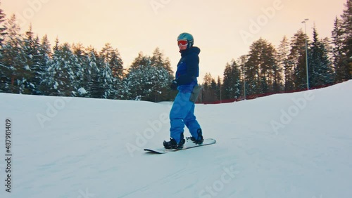 Young man snowboarding in the park photo