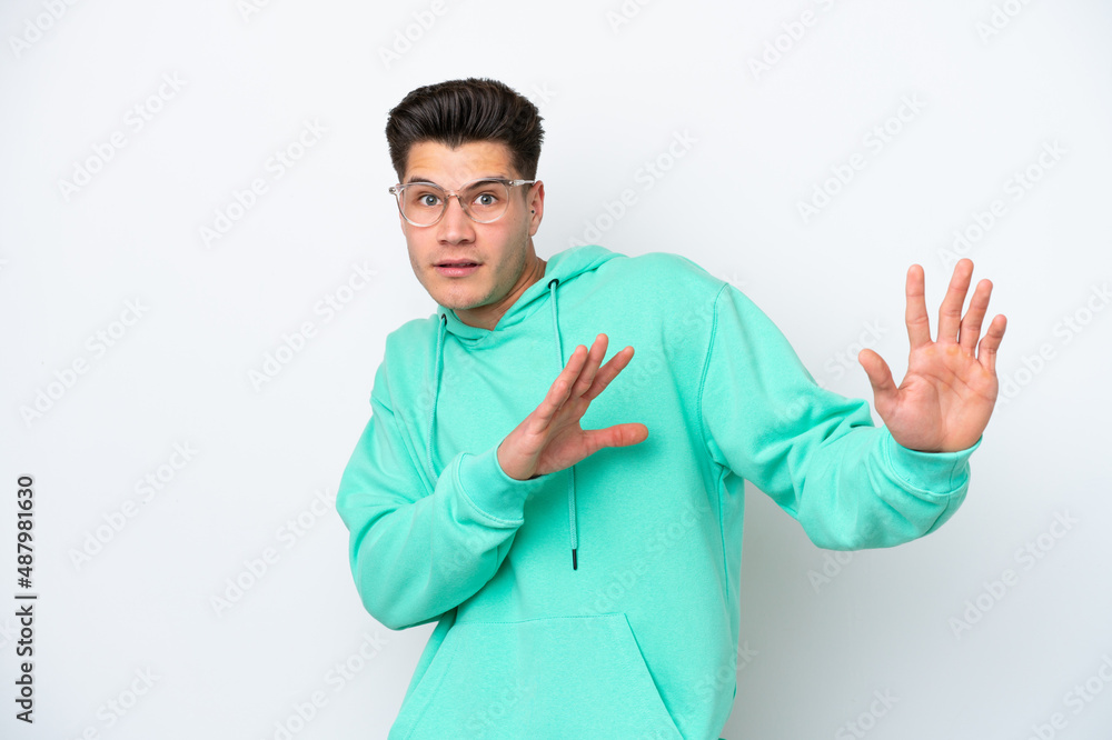 Young handsome caucasian man isolated on white bakcground nervous stretching hands to the front Young handsome caucasian man isolated on white bakcground nervous stretching hands to the front