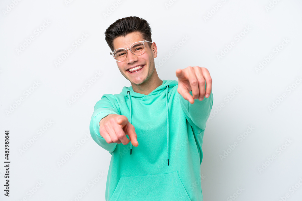 Young handsome caucasian man isolated on white bakcground pointing front with happy expression Young handsome caucasian man isolated on white bakcground pointing front with happy expression