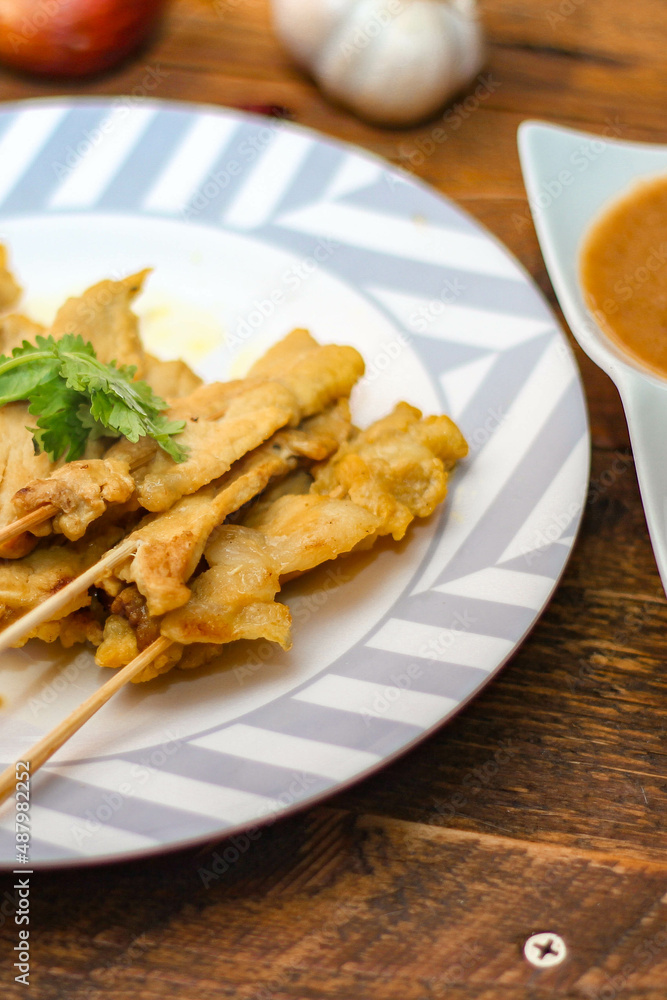 Pork satay - Grilled pork served with peanut sauce or sweet,sour sauce and toast, Thai street food and delicious food in the restaurant. Pork satay - Grilled pork served with peanut sauce or sweet,sour sauce and toast, Thai street food and delicious food in the restaurant.