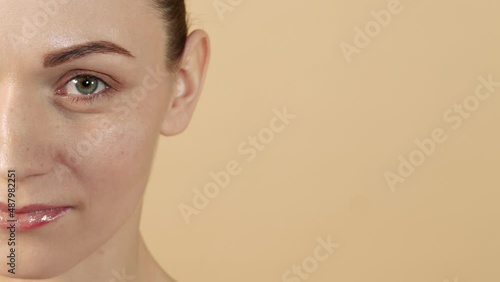 Close-up face of caucasian girl with healthy and smooth skin with copy space for advertising isolated on beige studio background. Skin care concept.