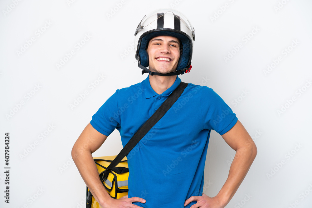Young caucasian man with thermal backpack isolated on white background posing with arms at hip and smiling Young caucasian man with thermal backpack isolated on white background posing with arms at hip and smiling