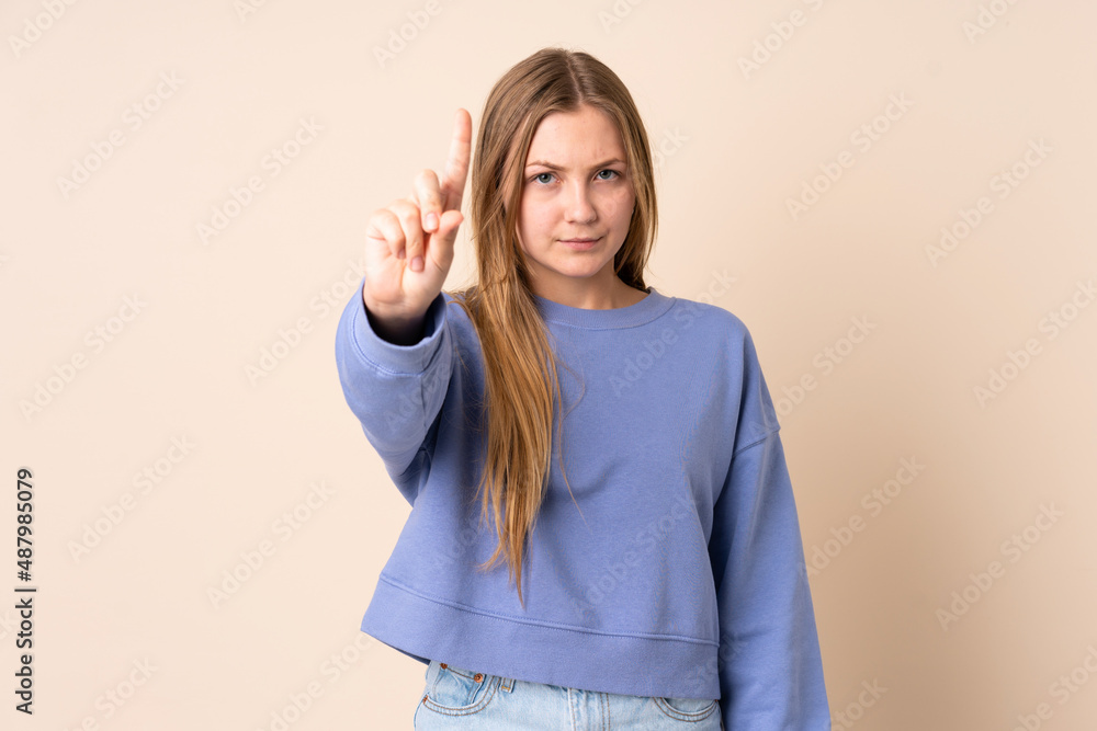 Teenager Ukrainian girl isolated on beige background counting one with serious expression Teenager Ukrainian girl isolated on beige background counting one with serious expression