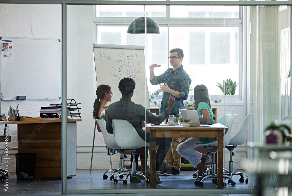 Explaining his vision. Shot of a group of coworkers in a boardroom meeting. Explaining his vision. Shot of a group of coworkers in a boardroom meeting.