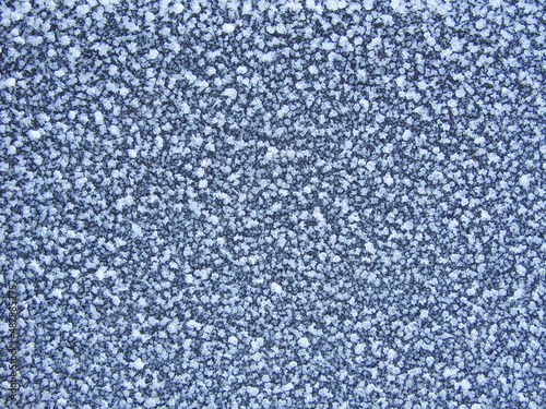 Blue frost texture on the surface. Winter background. Template for product display. Ice texture background. Frost, ice surface. Close up of decorative winter frozen pattern.