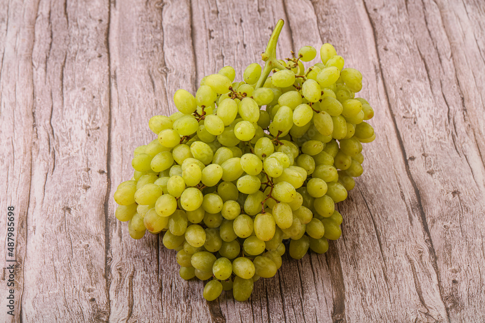 Green grape branch over background Green grape branch over background