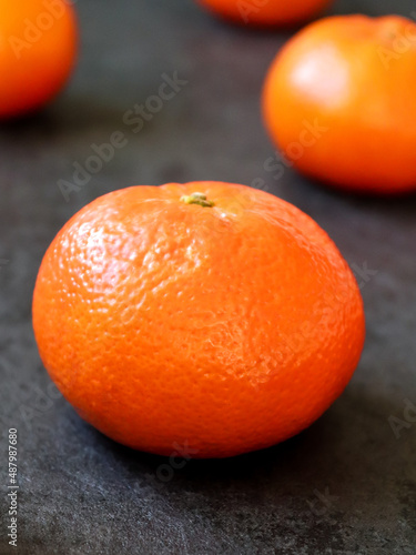 Close-up to fresh tangerine fruit on dark background