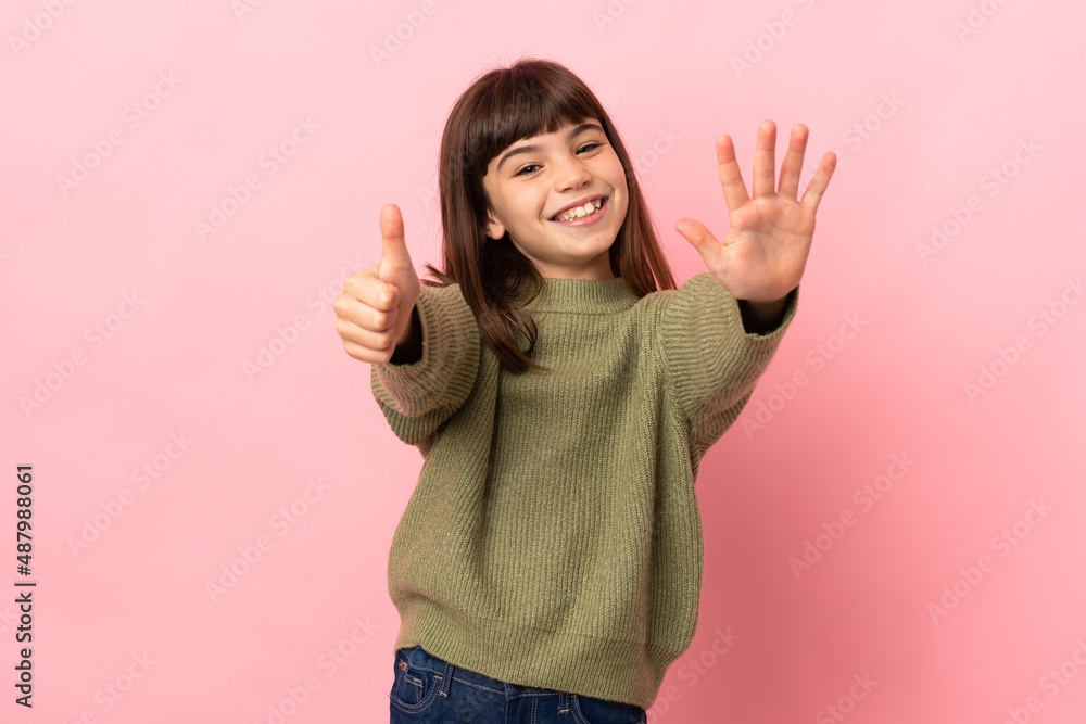 Little girl isolated on pink background counting six with fingers Little girl isolated on pink background counting six with fingers