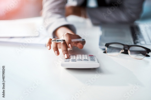 Every business move has a financial outcome. Cropped shot of a businesswoman using a calculator at her desk in a modern office.