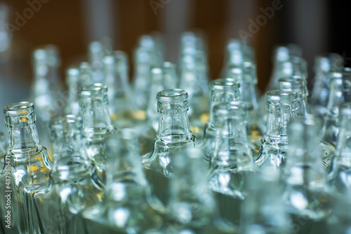 Large group of green recycled glass wine bottles at winery