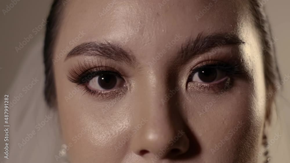 4k slow motion. Young beautiful Asian bride woman open her eye closeup. 4k slow motion. Young beautiful Asian bride woman open her eye closeup.