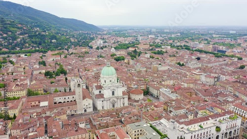 Brescia, Italy. Cathedral of Santa Maria Assunta. Flight over the city in cloudy weather, Aerial View Hyperlapse, Departure of the camera photo