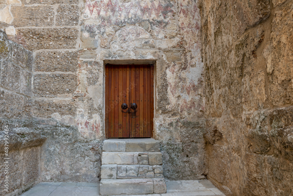 old stone building and wooden door. interior of Aspendos Roman ancient theater. 