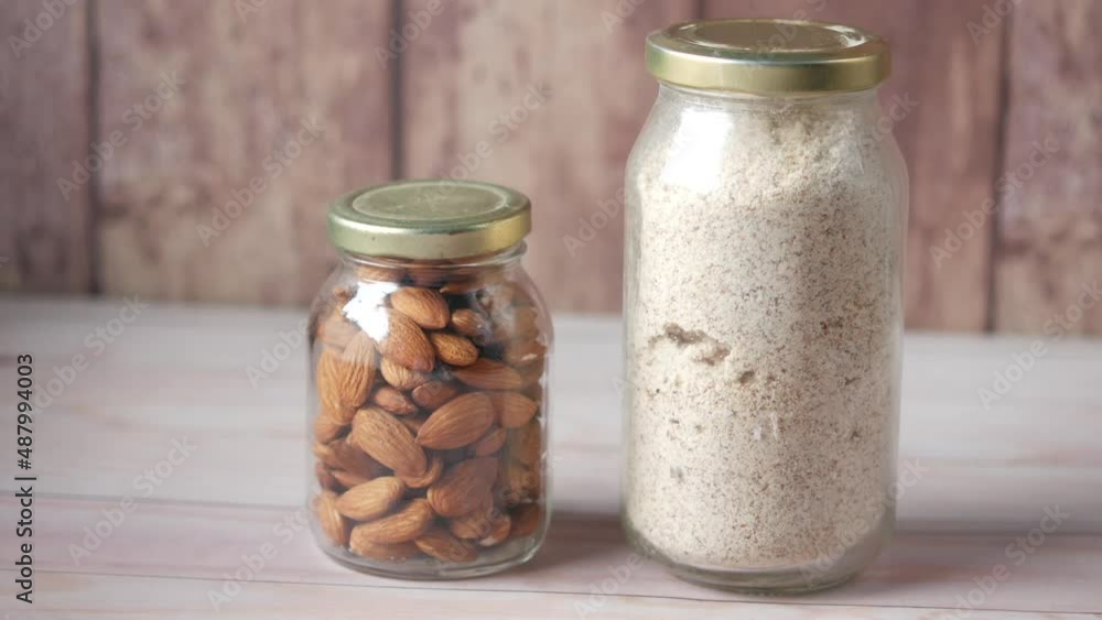 almond powder and almond in a jar on table, almond powder and almond in a jar on table,