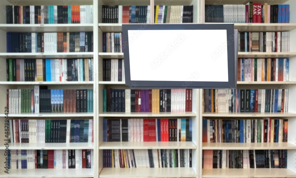 digital display in front of bookshelf