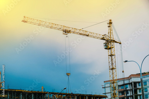 Construction of residential buildings, construction crane against the sky. Construction concept.