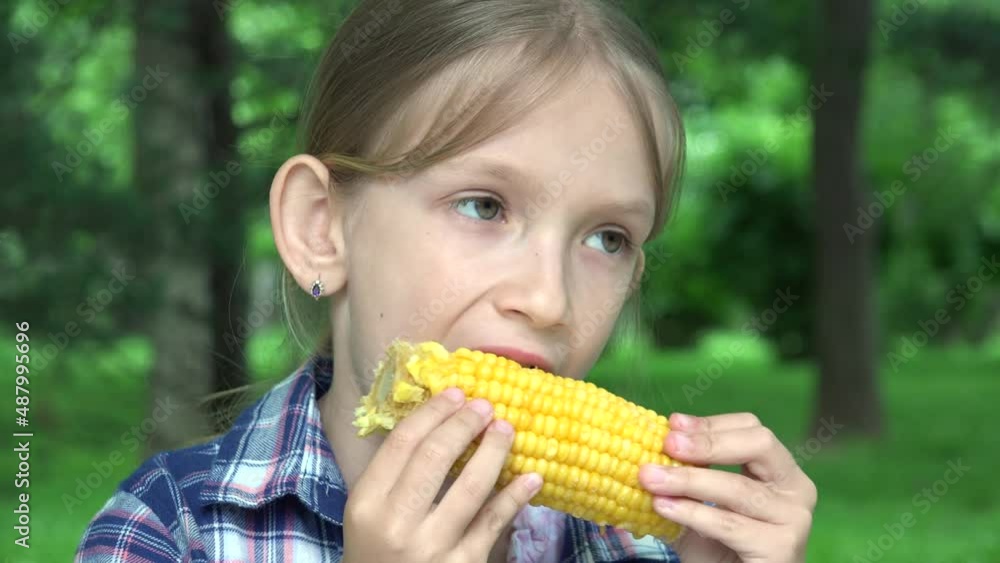 Kid Eating Boiled Corn Outdoor in Park, Hungry Girl Eats Healthy Snack Food, Young Blonde Child Relaxing Outdoor in Nature Kid Eating Boiled Corn Outdoor in Park, Hungry Girl Eats Healthy Snack Food, Young Blonde Child Relaxing Outdoor in Nature