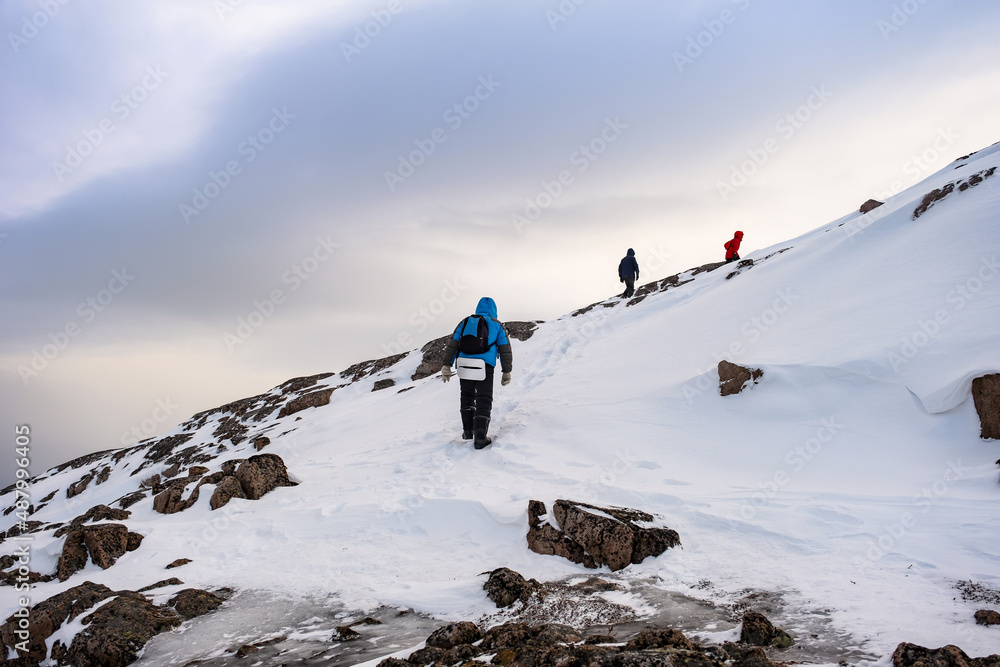 Teriberka, Russia. Tourists climb the mountains