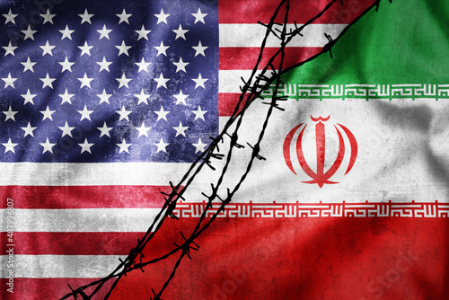 Grunge flags of Iran and USA divided by barb wire illustration