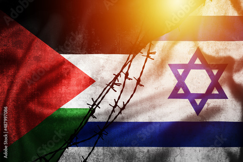 Foto Grunge flags of Palestine and Israel divided by barb wire sun haze illustration