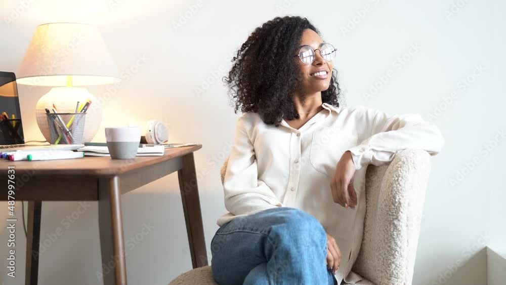Smiling young woman sits at workplace table. Confident beautiful female professional leader Smiling young woman sits at workplace table. Confident beautiful female professional leader