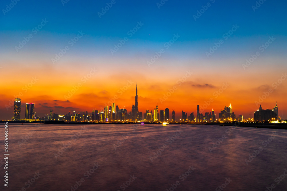Stunning shot of Dubai City Skyline in the evening with a colorful sky.