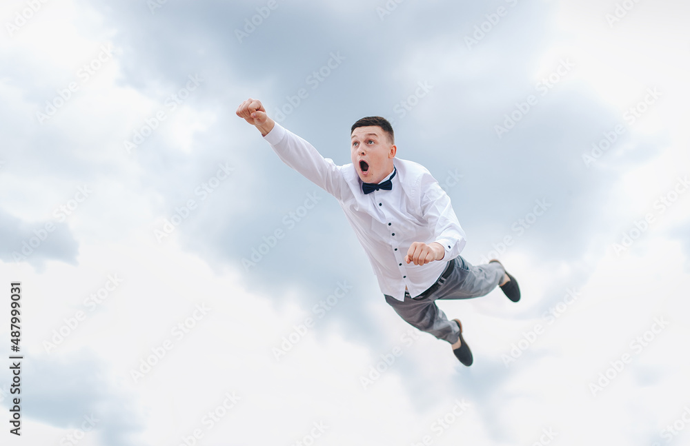A man, a businessman is flying in the sky, hurrying to work. Photography, concept. A man, a businessman is flying in the sky, hurrying to work. Photography, concept.