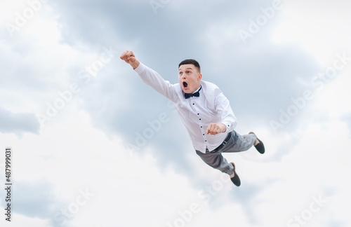 Wallpaper Mural A man, a businessman is flying in the sky, hurrying to work. Photography, concept. Torontodigital.ca