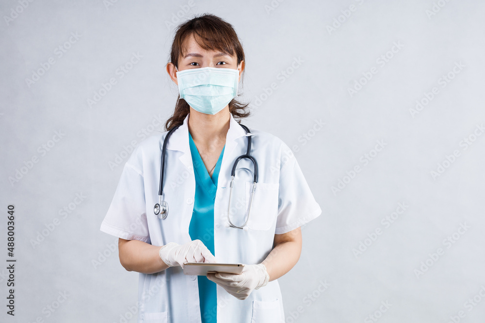 Covid19, coronavirus, healthcare and doctors concept. Portrait of professional confident young asian doctor in medical mask and white coat, stethoscope over neck, ready help patient, fight disease