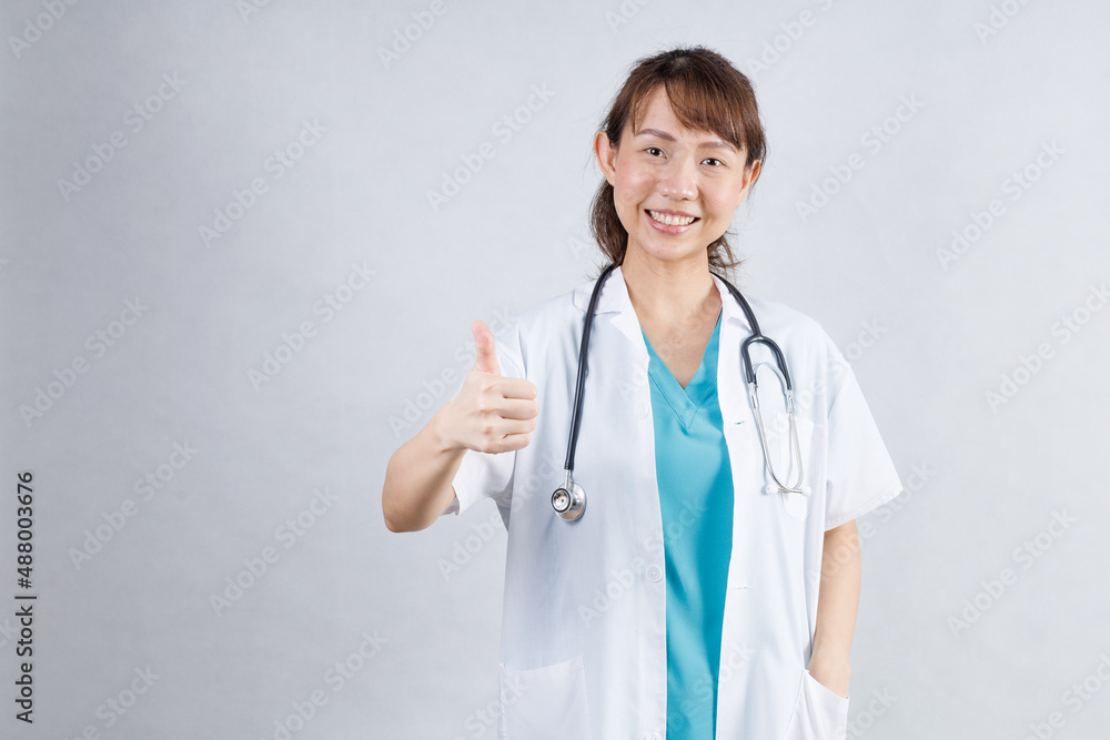 Happy beautiful female doctor in medical coat standing with crossed arms isolated on white.Asia look Happy beautiful female doctor in medical coat standing with crossed arms isolated on white.Asia look