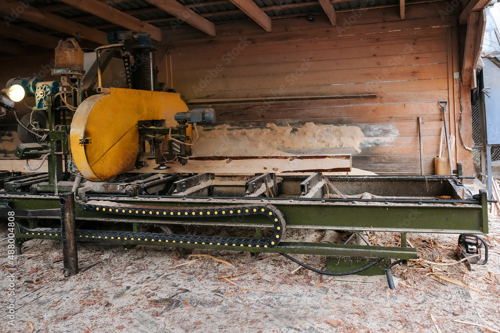 The process of processing wood at an old sawmill, side view