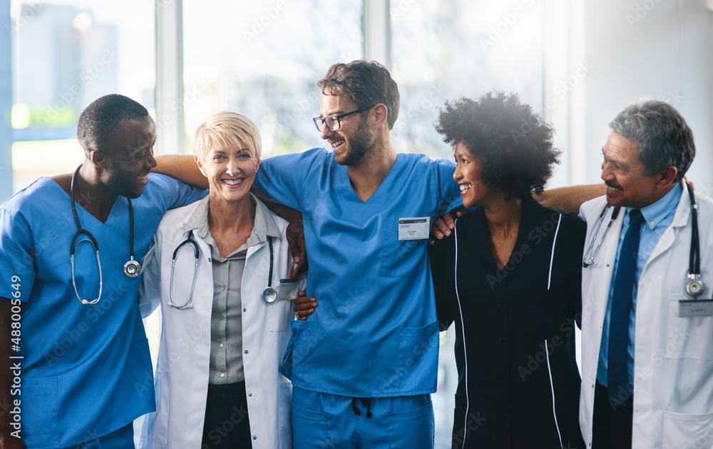 Here for each other, here for you. Portrait of a diverse team of doctors standing together in a hospital.
