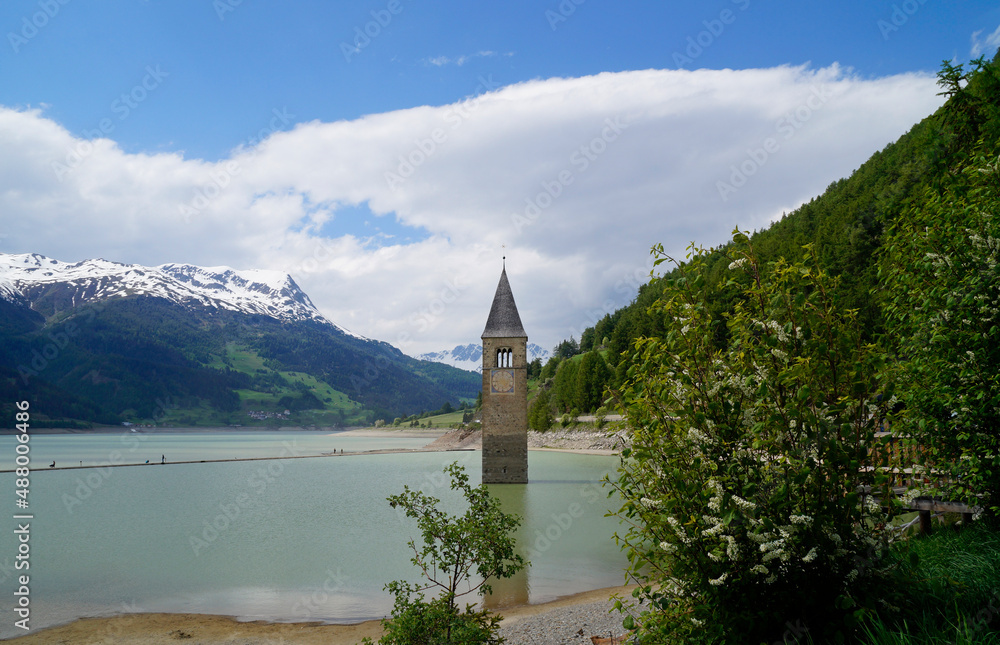 a picturesque view of lake Resia and the sunken church steeple of Lago di Resia in the Curon region (Vinschgau, South Tyrol, Italy)	
