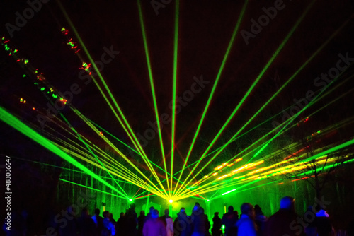 Green and red laser beams on a black background