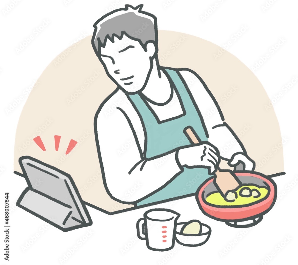 タブレットでレシピを見ながら、キッチンで料理する若い男性 タブレットでレシピを見ながら、キッチンで料理する若い男性