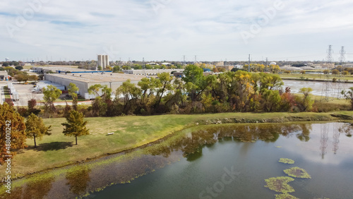 Lakeside commercial warehouse and tower transmission tower in industrial district Carrollton Texas, America in aerial view