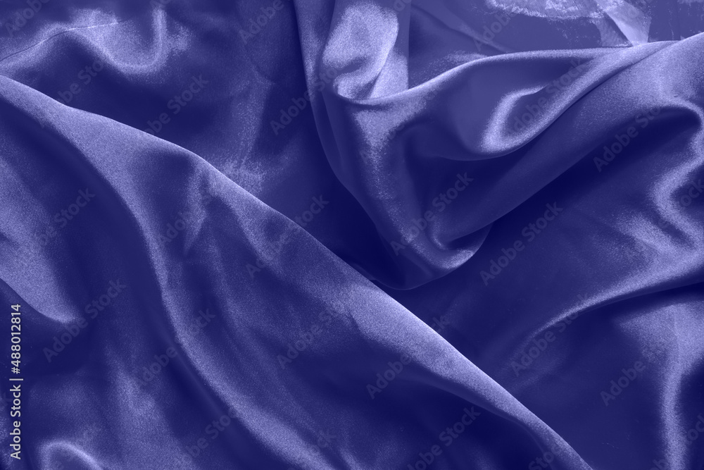Fototapeta premium Beautiful violet silk background. Draped background of fabric, texture. Copy space. Close up