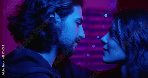 passion, attraction -couple looks into each other's eyes and kisses passionately