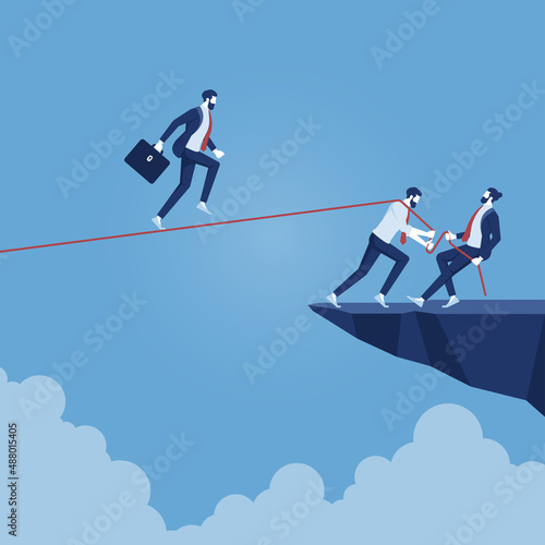 businessman walking on rope walk way pulled by team, concept for teamwork and support