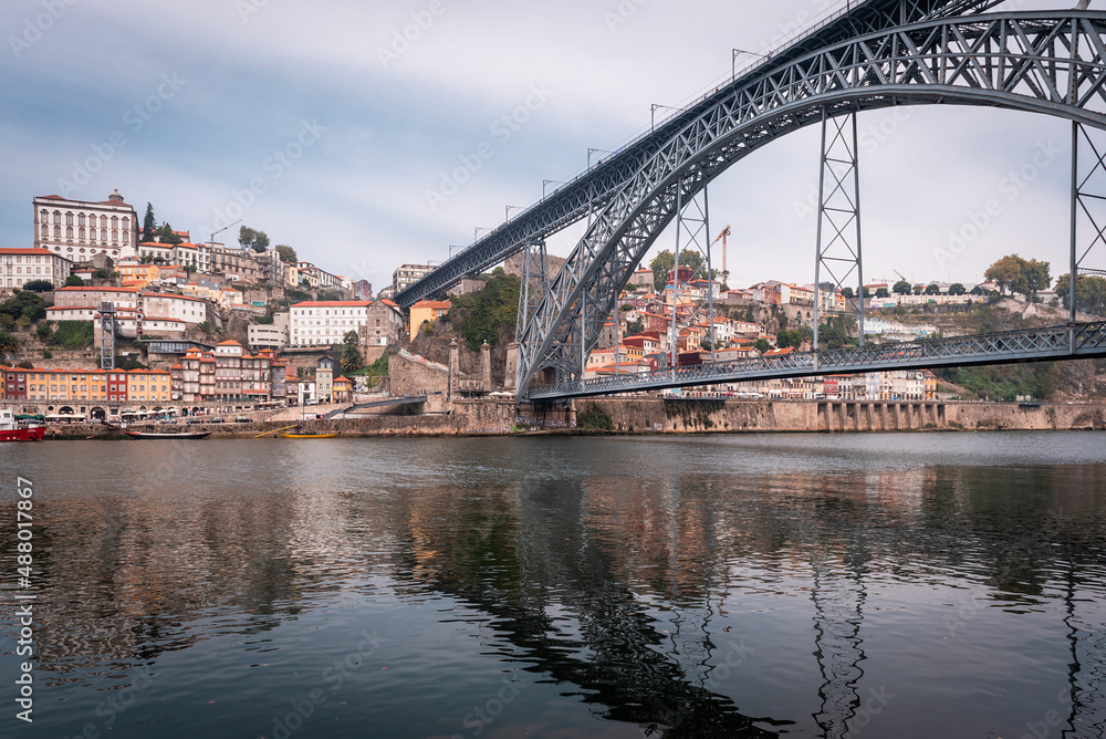 Views of the city of Porto from the Douro river with the Dom Luis I bridge in the foreground.