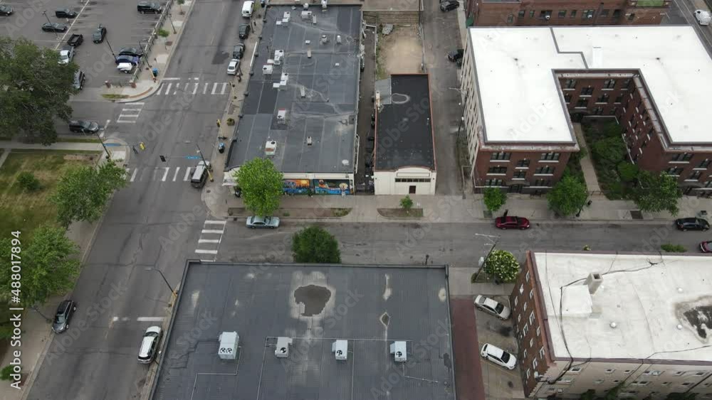 Birds eye view of older section of downtown Minneapolis. Older buildings in various states of repair, parking lots, apartments, traffic, rooftops, trees, variety of colors. Birds eye view of older section of downtown Minneapolis. Older buildings in various states of repair, parking lots, apartments, traffic, rooftops, trees, variety of colors.