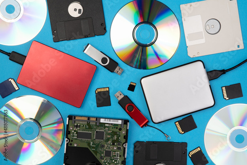 фотографія Data storage devices such as CDs, hard drives, pen drives and other, top view on