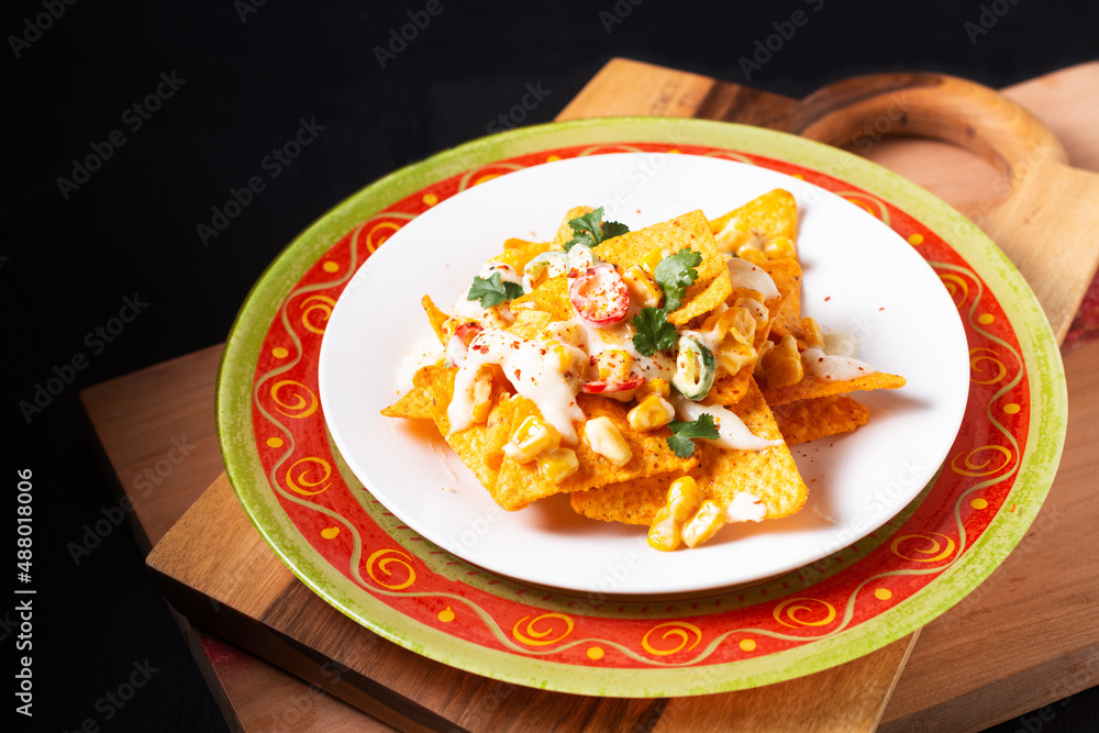 Food concept Maxican Corn Nachos on wooden board with copy space